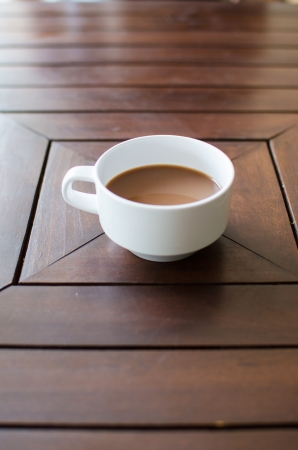 Hot coffee latte on brown wood tableの写真素材