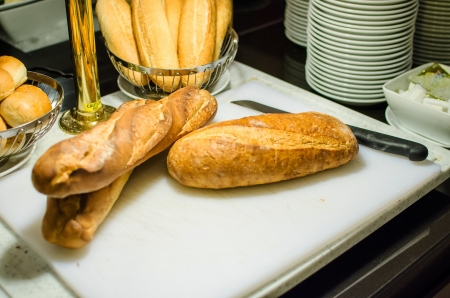 Breads on cutting board preparing for slice in restaurantの写真素材