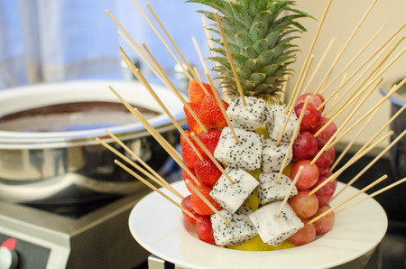 Fresh fruit with chocolate fondue in restaurantの写真素材