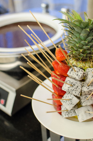 Fresh fruit with chocolate fondue in restaurantの写真素材
