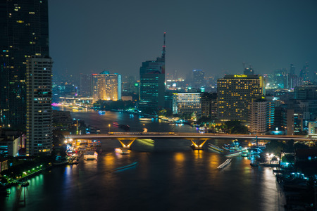 Bangkok city skyline by the river in a night scene viewの写真素材