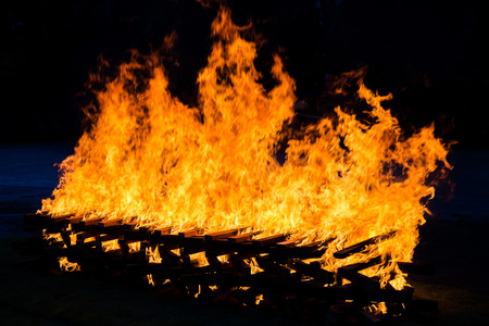 Fire burning wood pile , closeup abstract background