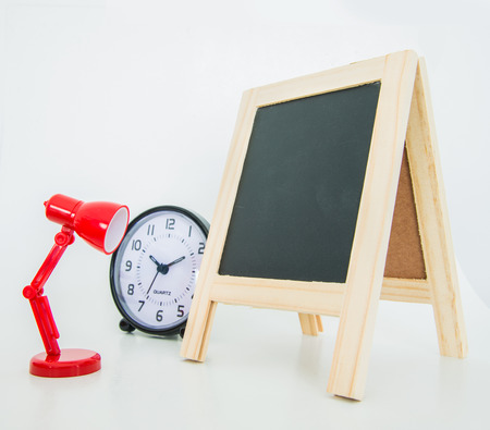Office objects on white background, Alarm clock, Desk lamp, Wood chalkboardの写真素材