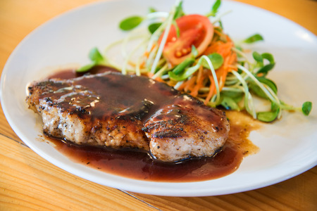 Juicy and tasty grilled pork steak with pepper sauceの写真素材