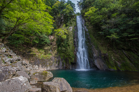 Beautiful waterfall deep inside forest in Japanの写真素材