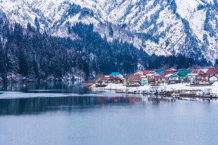 Village nearby the river in winter season in Japanの写真素材