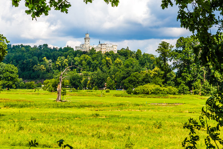 Picturesque view of beautiful Hluboka castle with cloudy sky and forest-Hluboka nad Vltavou,Czech Republic, Europeのeditorial素材