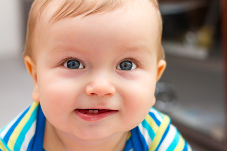 Portrait Of Adorable Smiling Little Boy With Two Toothsの写真素材