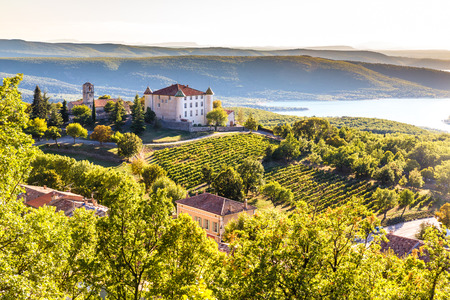 View Of Aiguines Village And Renaissance-style Chateau Overlooking Lac de Sainte Croix Lake-Alpes de Haute Provence,France View Of Aiguines Village And Renaissance-style Chateau Overlooking Lac de Sainte Croix Lake-Alpes de Haute Provence,France