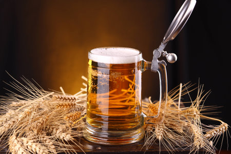 Mug of light beer on a wooden chest with barley earsの写真素材