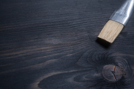 Painting brush tip on a dark wooden surfaceの写真素材