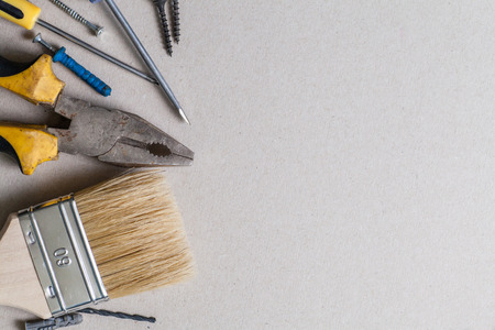 An assortment of various tools framing an empty light gray background areaの写真素材