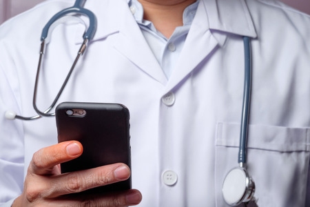 Doctor using mobile smart phone.