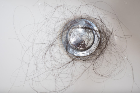 Hair loss problem in white sink.の写真素材