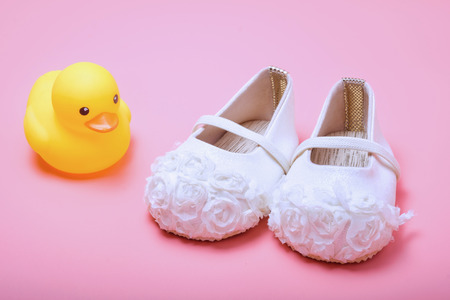 cute baby shoes for kids on pink backgroundの写真素材