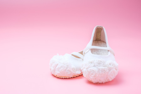 cute baby shoes for kids on pink backgroundの写真素材