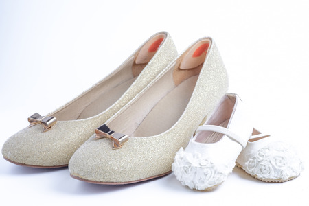 woman and baby shoes on white background.の写真素材