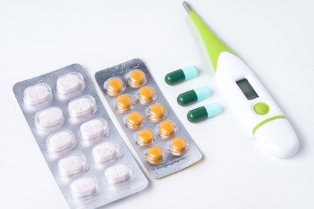 digital thermometer and blister package of medicine
