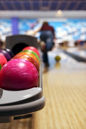 Bowling ball machine with person bowling in the backgroundの写真素材