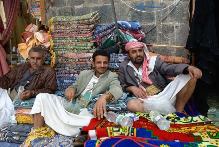 SANAA, YEMEN - MARCH 6: Three unidentified men sell carpet on Mar 6, 2010 in Sanaa, Yemen. Open markets play a central role in the social-economic life of one of the poorest countries in the Arab Worldのeditorial素材