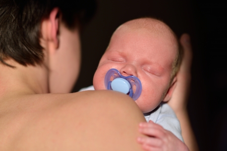 Newborn baby on the fathers handsの写真素材