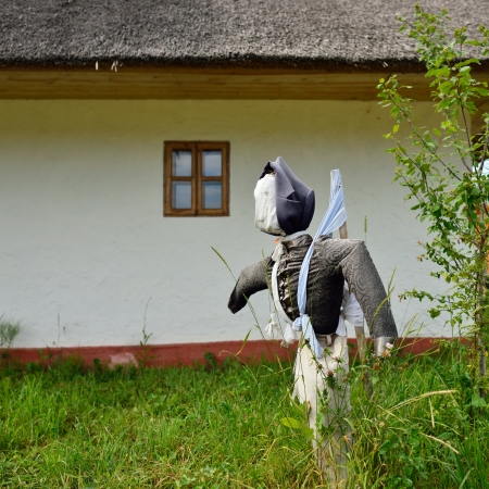 Scarecrow in courtyard of old farmhouse, Russiaの写真素材