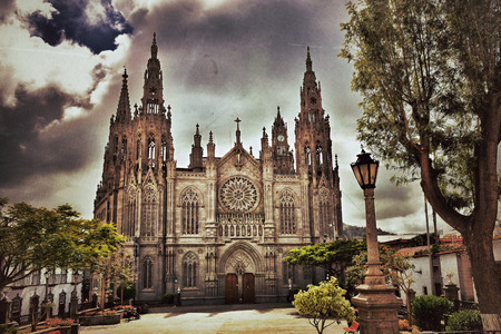 View on Medieval beautiful parish church of San Juan Bautista - impressive Gothic Cathedral in Arucas, Gran Canaria, Spain  Filtered  Vintage effect applied  の写真素材