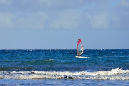 GRAN CANARIA - FEB 28, 2014   Windsurfing at sunset in the Atlantic ocean, Gran Canaria  Most popular water activity on the islandのeditorial素材