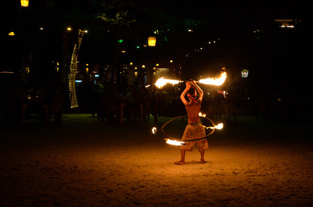 KOH SAMET, THAILAND - DEC 26, 2011   Young boy dans during  the night fire show on a beach  One from most popular tourist attraction in the Samet island のeditorial素材