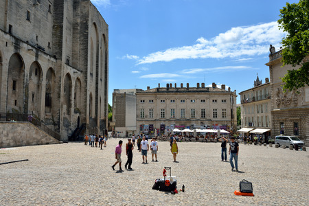 AVIGNON, FRANCE - JUL 12, 2014: Tourists on square of Popes Palace. Popes Palace is the main historical site in Provence and one of the largest and most important medieval Gothic buildings in Europeのeditorial素材