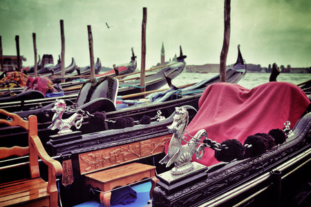 Gondola moored by Saint Mark square with San Giorgio di Maggiore church in the background at sunrise - Venice, Italy, Europe. Filtered image. Vintage effect appliedの写真素材