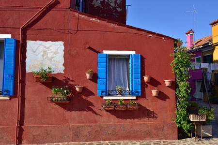 BURANO, ITALY - SEPT, 2014: Courtyard with flowers between colorful houses on the famous island Burano, Venice. Venice and the Venetian lagoon are on the UNESCO World Heritage Listのeditorial素材