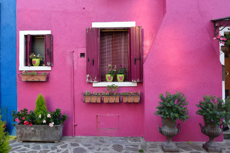Courtyard with flowers between colorful houses on the famous island Burano, Venice. Venice and the Venetian lagoon の写真素材