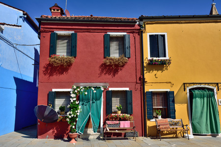 Courtyard with flowers between colorful houses on the famous island Burano, Venice. Venice and the Venetian lagoon are on the UNESCO World Heritage Listのeditorial素材