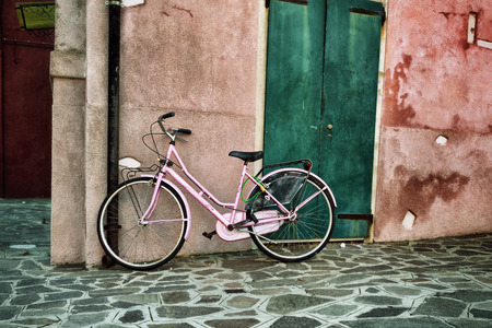 A bike against the wall at house, Burano, Italy. Filtered imageのeditorial素材