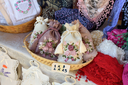 BURANO, ITALY - SEPT 23, 2014: Typical burano souvenirs handmade lace and embroidery on street market. Burano Island is the oldest place for lace craftsmanship.のeditorial素材