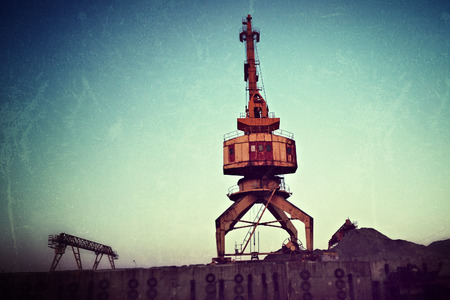 Working crane in shipyard at dusk, Vologda, Russia. Filtered image
