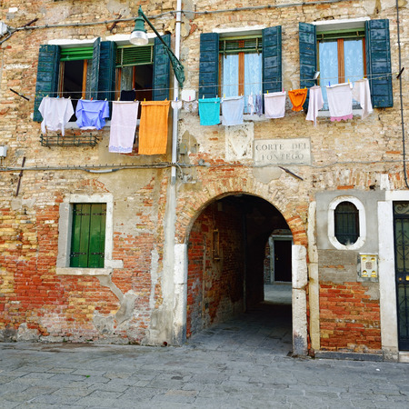 Dried dress on a facade historic building of the historical city of Venice in Italy, famous UNESCO World Heritage Siteのeditorial素材