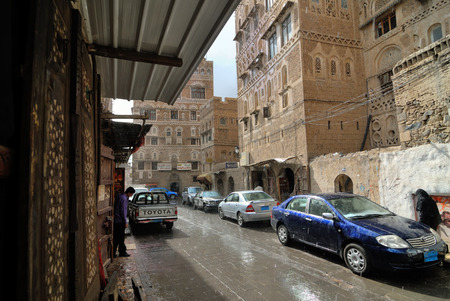 SANAA, YEMEN - MAR 6, 2010: Very rare weather phenomenon - rain on the street in old city in Sanaa. Inhabited for more than 2.500 years at an altitude of 2.200 m, Sanaa is a UNESCO World Heritage Cityのeditorial素材