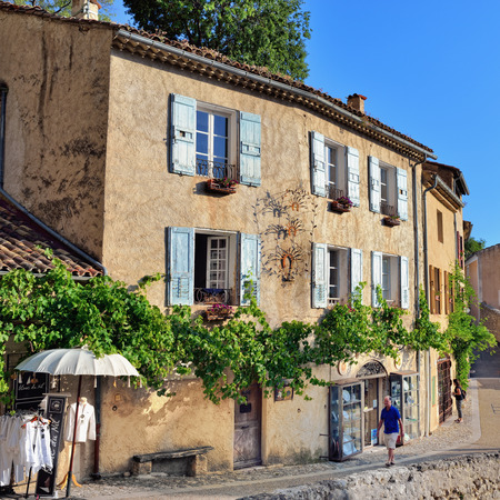 MOUSTIERS SAINTE-MARIE, FRANCE - JUL 18, 2014: Tourists on the narrow street of the beautiful medieval village. Moustiers Sainte Marie village is included in list of "The most beautiful villages of France"のeditorial素材