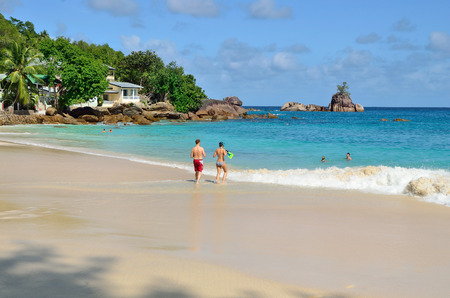 MAHE, SEYCHELLES - JULY 07, 2011: Unidentified tourists have a rest on the beautiful sandy beach Anse Soleil one from the most popular beaches at the islandのeditorial素材