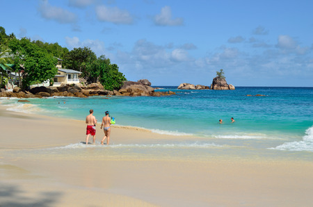 MAHE, SEYCHELLES - JULY 07, 2011: Unidentified tourists have a rest on the beautiful sandy beach Anse Soleil one from the most popular beaches at the islandのeditorial素材