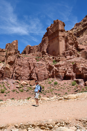 PETRA, JORDAN - APR 2, 2015: Nabataeans capital city. Unidentified tourist man looks around. Petra's temples, tombs, theaters and other buildings are scattered over 400 square miles.のeditorial素材