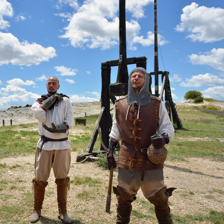 LES BAUX, FRANCE - JUL 9, 2014: Amateur historical reconstruction of medieval wars. Mens dressed as medieval warriors stand near the catapult. Les Baux castleのeditorial素材