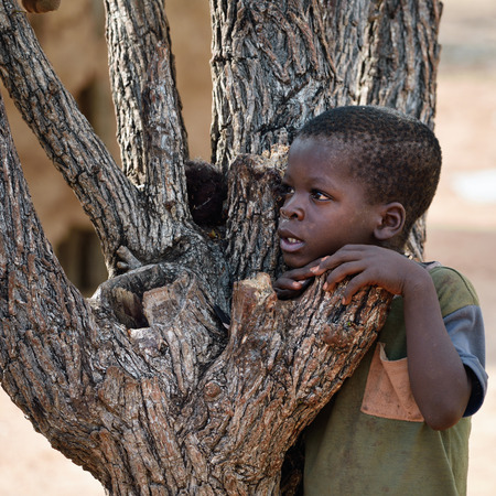 KAMANJAB, NAMIBIA - FEB 1, 2016: Little unidentified Himba boy shown in himba tribe villageのeditorial素材