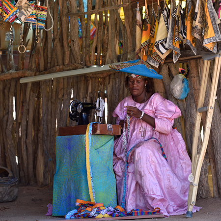 KAOKOLAND, NAMIBIA - FEB 1, 2016: Unidentified Herero Woman in traditional clothes with sewing...