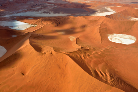 Aerial view of high red dunes, located in the Namib Desert, in the Namib-Naukluft National Park of Namibia, Africaの写真素材