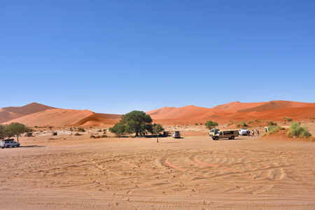 SOSSUSVLEI, NAMIBIA - JAN 30, 2016: Tourists visit the  Namib-Naukluft National Park at sunrise. The most visited place in Namibiaのeditorial素材