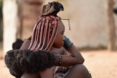 KAMANJAB, NAMIBIA - FEB 1, 2016: Young unidentified Himba woman with the typical necklace and...