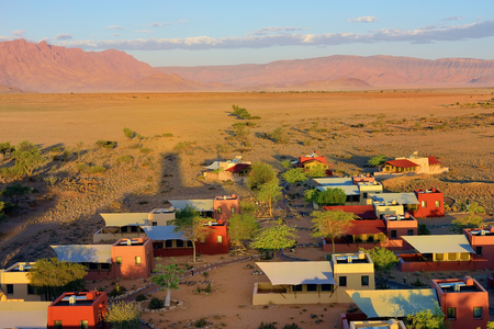SOSSUSVLEI, NAMIBIA - JAN 30, 2016: Accommodation units in the Sossusvlei Lodge. View from above at sunset. The most popular place in Namib-Naukluft park.のeditorial素材